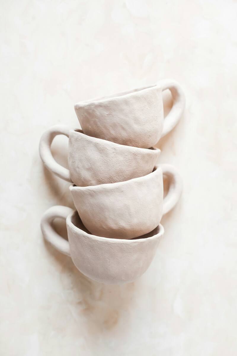 A pair of cream stoneware cups