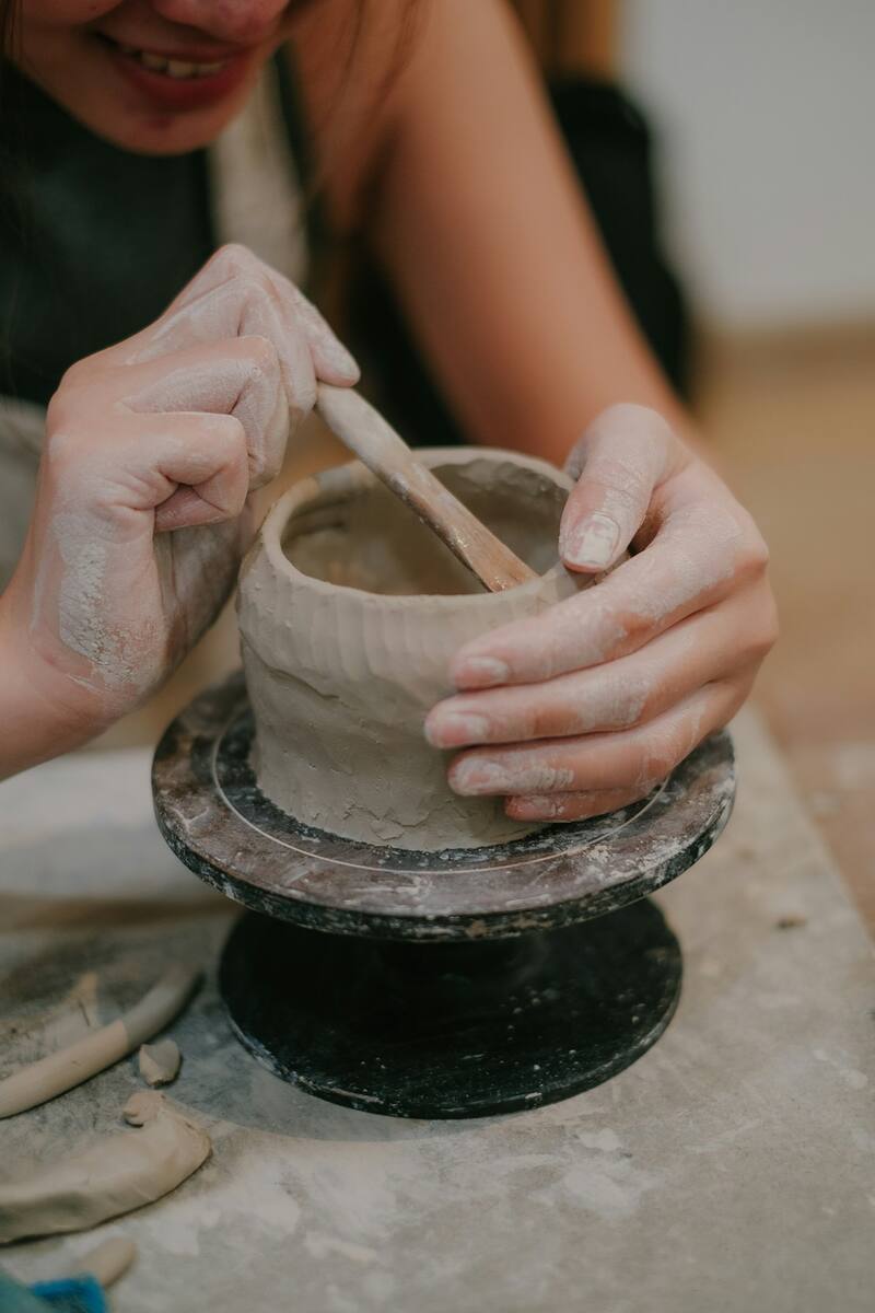 Hands kneading a block of clay